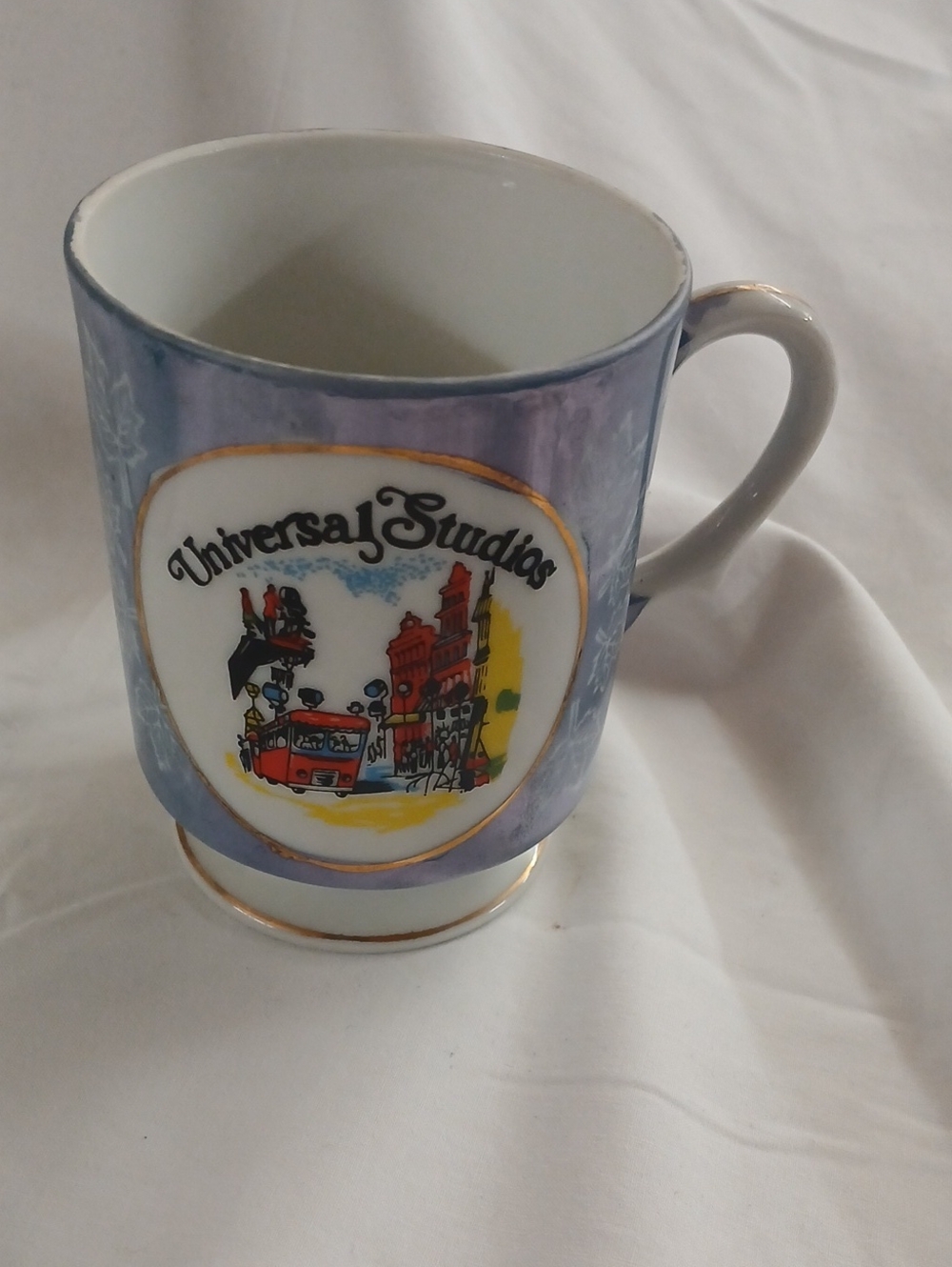 Universal Lavender and Gold Trim Ceramic Mug with Theme Park Artwork